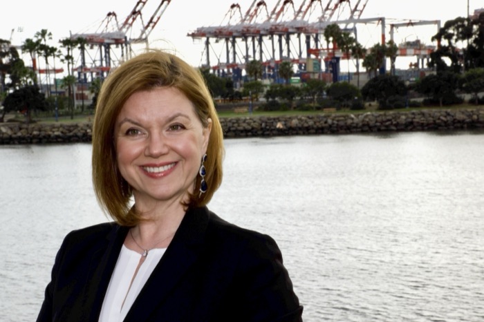Kat Janowicz at the Port of Long Beach, container cranes behind her
