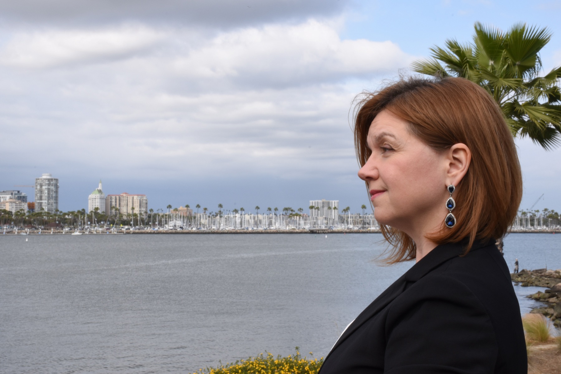 Kat Janowicz looking across the water toward the Long Beach skyline and marina